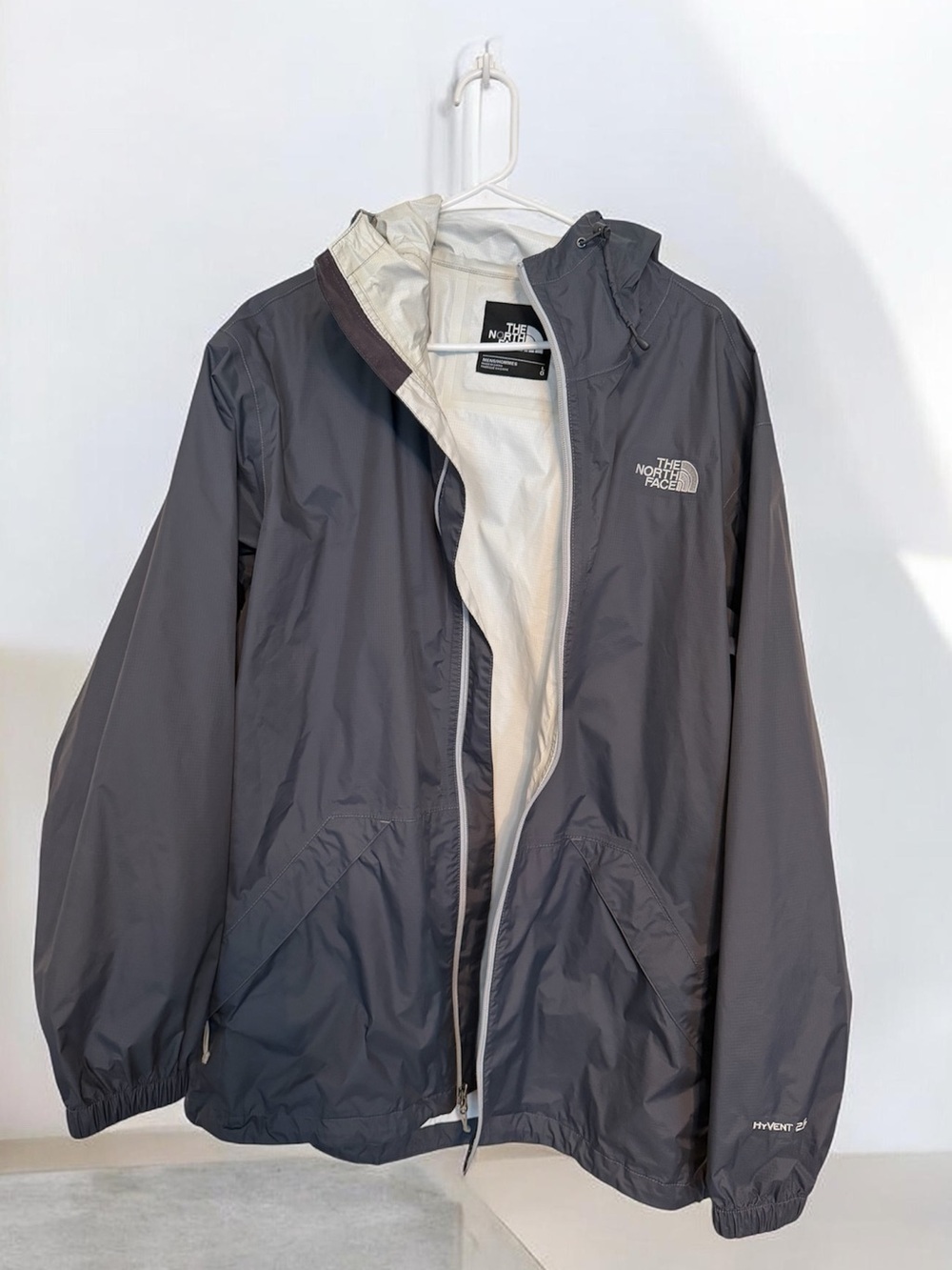 Gray The North Face HyVent hooded rain jacket with a full zip and elastic cuffs